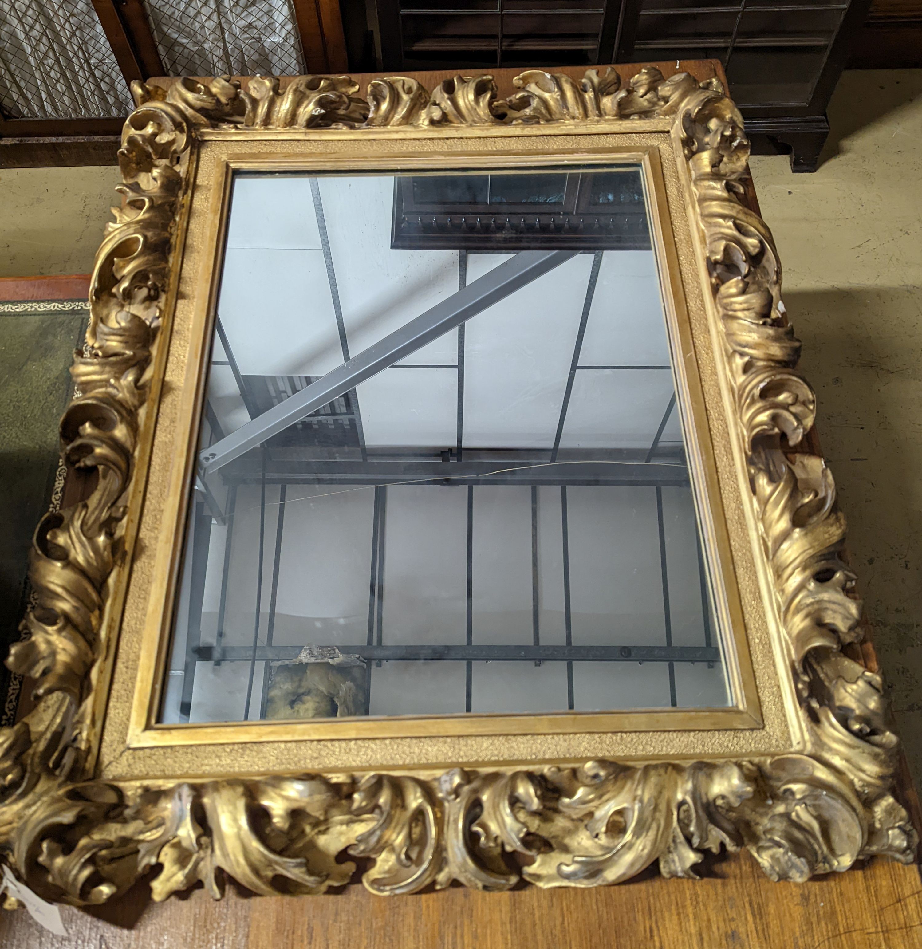 A large 19th century rectangular carved giltwood wall mirror with acanthus scroll frame, width 76cm, height 94cm